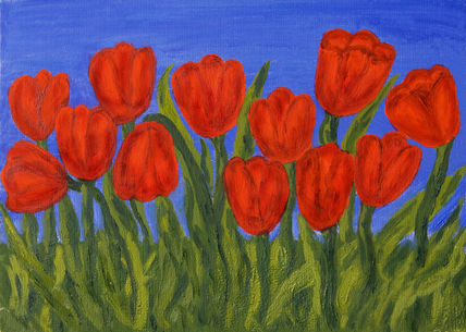 Red tulips on blue sky