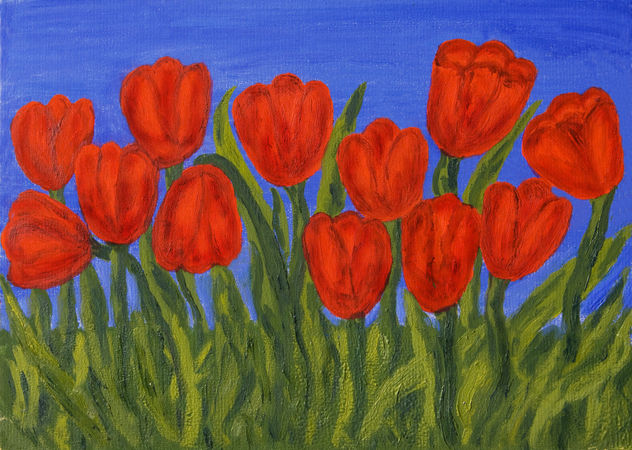 Red tulips on blue sky
