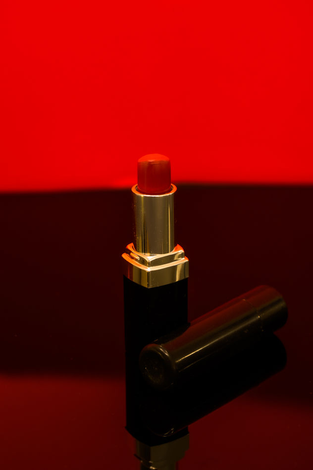 red lipstick with a red light background