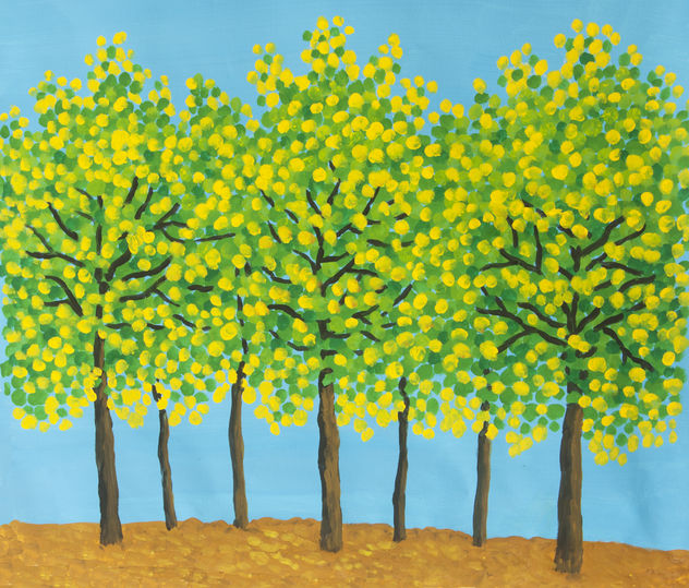 Yellow-green trees on blue sky