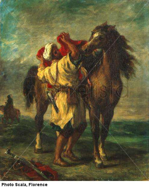 Árabe ensillando su caballo