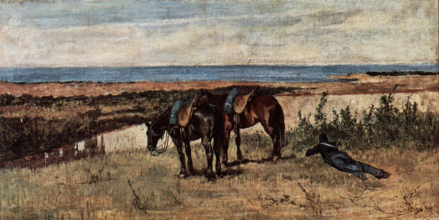 Soldado con dos caballos en la orilla del mar