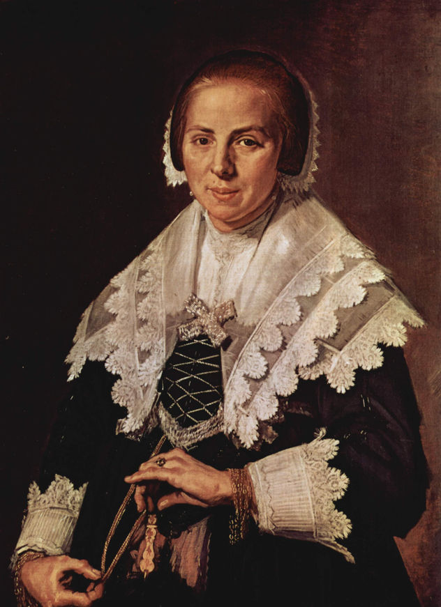 Retrato de una mujer de pie con guantes en las manos