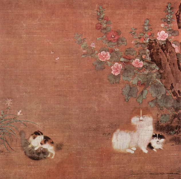 Gatos con crías en un jardín