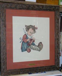 Niña tejiendo punto