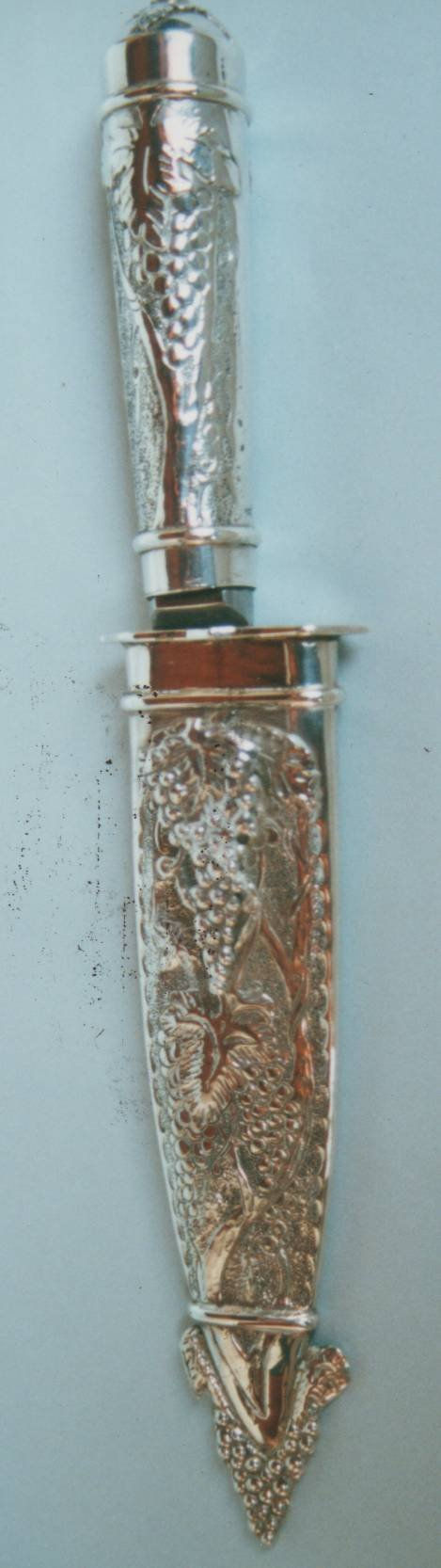 Cuchillo con uvas y hojas de parra