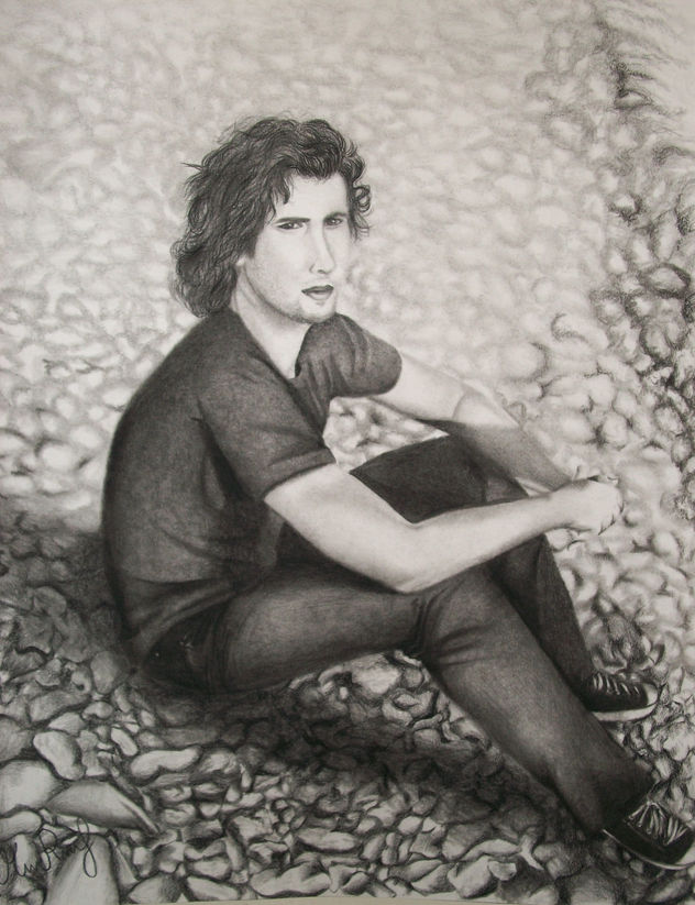 Young man sitting on rocks