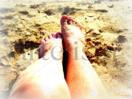 Piernas en la arena