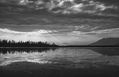 The sun is breaking through the clouds over the Dal - Lake