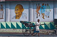 Kolkata - A rickshaw-puller passing Mahatma Gandhi Rd. metro-station